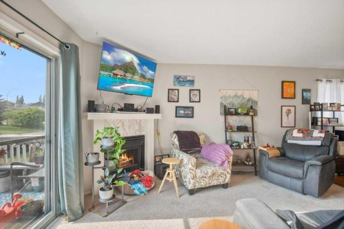 45 Hangingstone Drive, Lacombe, AB - Indoor Photo Showing Living Room With Fireplace