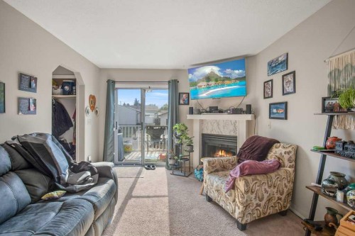 45 Hangingstone Drive, Lacombe, AB - Indoor Photo Showing Living Room With Fireplace