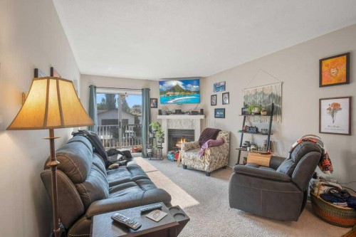 45 Hangingstone Drive, Lacombe, AB - Indoor Photo Showing Living Room With Fireplace
