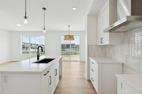 17 Southborough Common, Cochrane, AB - Indoor Photo Showing Kitchen With Double Sink With Upgraded Kitchen
