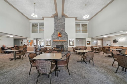 330-56 Carroll Crescent, Red Deer, AB - Indoor Photo Showing Dining Room With Fireplace