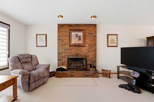 77 Allan Close, Red Deer, AB - Indoor Photo Showing Living Room With Fireplace