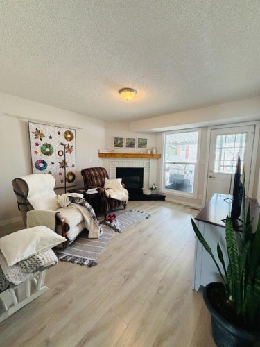 4741 49A Avenue, Lacombe, AB - Indoor Photo Showing Living Room With Fireplace