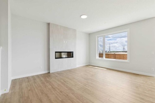 546 Hotchkiss Manor, Calgary, AB - Indoor Photo Showing Other Room With Fireplace