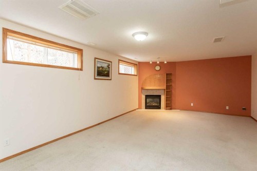 4908 55 Street, Alix, AB - Indoor Photo Showing Other Room With Fireplace
