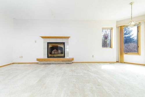 11-4700 Fountain Drive, Red Deer, AB - Indoor Photo Showing Living Room With Fireplace