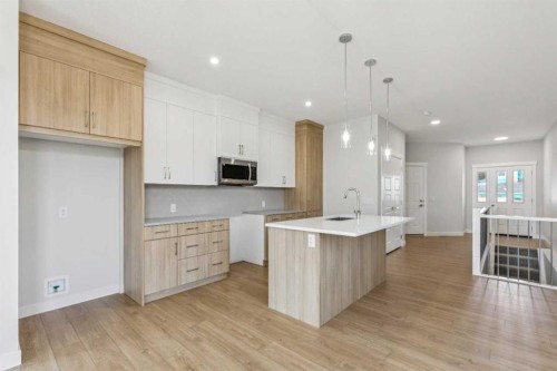 73 Southborough Square, Cochrane, AB - Indoor Photo Showing Kitchen With Upgraded Kitchen
