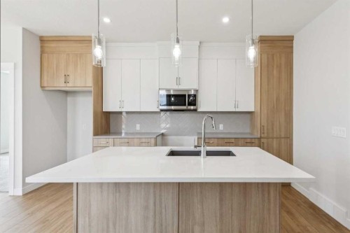 73 Southborough Square, Cochrane, AB - Indoor Photo Showing Kitchen With Upgraded Kitchen