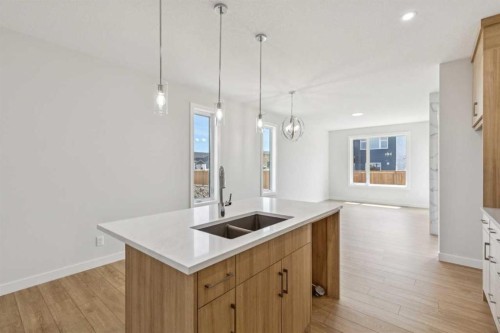 73 Southborough Square, Cochrane, AB - Indoor Photo Showing Kitchen With Double Sink With Upgraded Kitchen