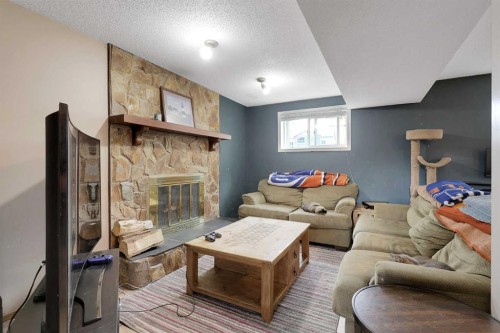 250 Cornett Drive, Red Deer, AB - Indoor Photo Showing Living Room With Fireplace