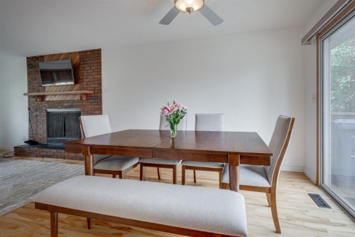 8 Nielsen Close, Red Deer, AB - Indoor Photo Showing Dining Room With Fireplace