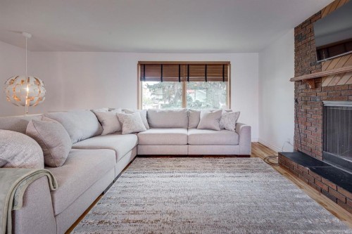 8 Nielsen Close, Red Deer, AB - Indoor Photo Showing Living Room With Fireplace