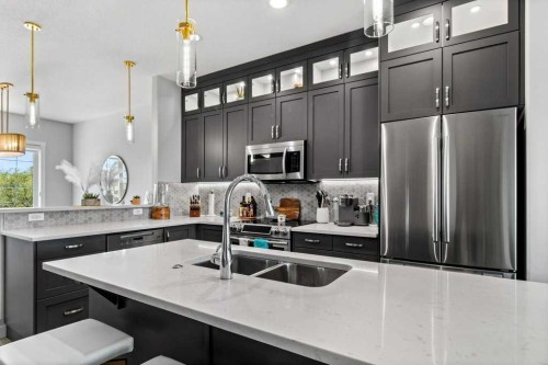 113-5210 Lakeshore Drive, Sylvan Lake, AB - Indoor Photo Showing Kitchen With Stainless Steel Kitchen With Double Sink With Upgraded Kitchen