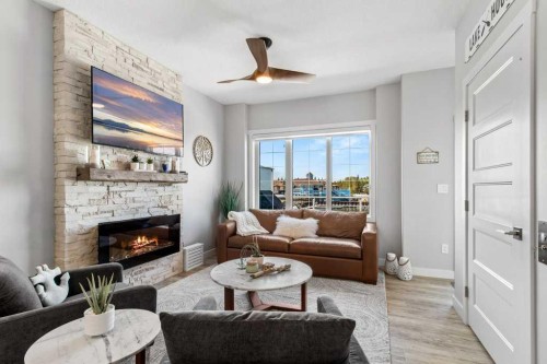 113-5210 Lakeshore Drive, Sylvan Lake, AB - Indoor Photo Showing Living Room With Fireplace