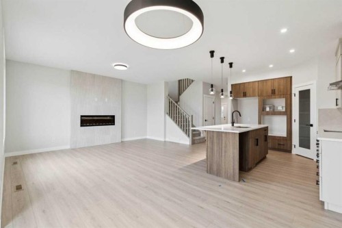 271 Bridgeport Circle, Chestermere, AB - Indoor Photo Showing Kitchen With Fireplace