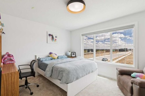 814 Bluerock Way Sw, Calgary, AB - Indoor Photo Showing Bedroom