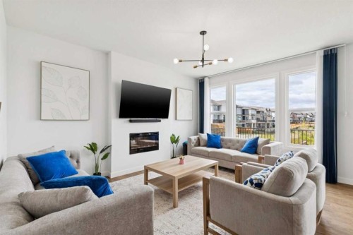814 Bluerock Way Sw, Calgary, AB - Indoor Photo Showing Living Room With Fireplace