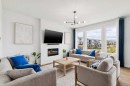814 Bluerock Way Sw, Calgary, AB  - Indoor Photo Showing Living Room With Fireplace 