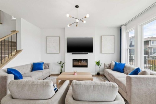 814 Bluerock Way Sw, Calgary, AB - Indoor Photo Showing Living Room With Fireplace