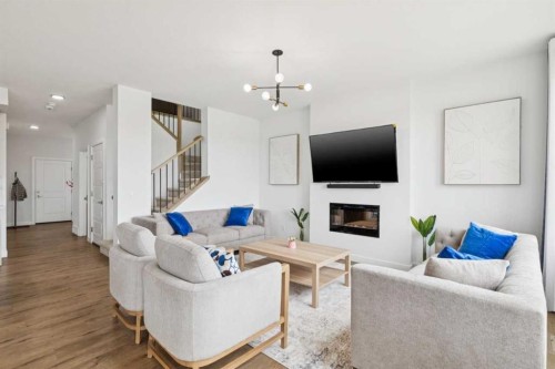 814 Bluerock Way Sw, Calgary, AB - Indoor Photo Showing Living Room With Fireplace