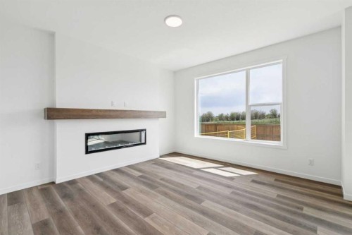 156 Southborough Common, Cochrane, AB - Indoor Photo Showing Living Room With Fireplace