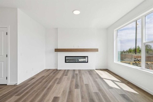 156 Southborough Common, Cochrane, AB - Indoor Photo Showing Living Room With Fireplace