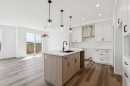 156 Southborough Common, Cochrane, AB  - Indoor Photo Showing Kitchen With Upgraded Kitchen 