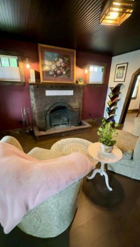 4836 49 Street, Innisfail, AB - Indoor Photo Showing Other Room With Fireplace