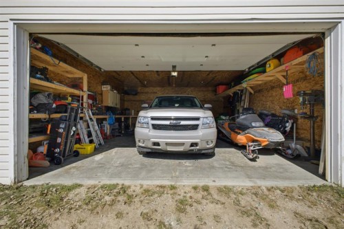 62 Mcdougall Close, Penhold, AB - Indoor Photo Showing Garage