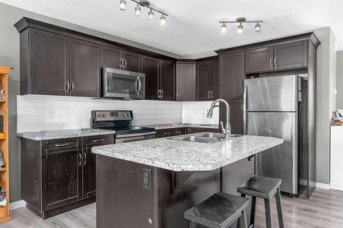 22 Hawthorn Place, Sylvan Lake, AB - Indoor Photo Showing Kitchen With Stainless Steel Kitchen With Double Sink With Upgraded Kitchen