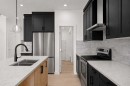 91 Heritage Manor, Cochrane, AB  - Indoor Photo Showing Kitchen With Stainless Steel Kitchen With Double Sink With Upgraded Kitchen 