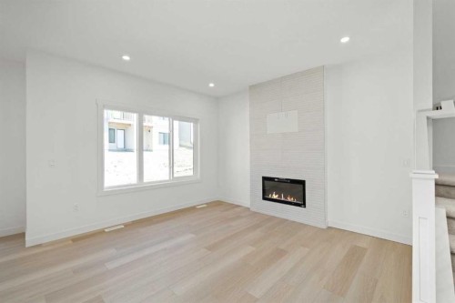 91 Heritage Manor, Cochrane, AB - Indoor Photo Showing Other Room With Fireplace