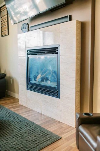 5007B 46 Street, Stettler, AB - Indoor Photo Showing Other Room With Fireplace
