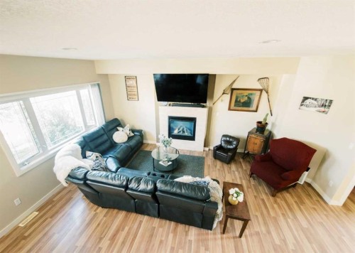 5007B 46 Street, Stettler, AB - Indoor Photo Showing Living Room With Fireplace