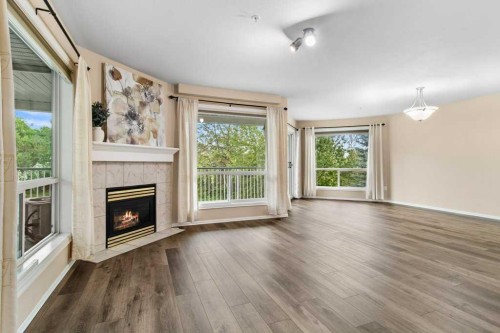211-6118 53 Avenue, Red Deer, AB - Indoor Photo Showing Living Room With Fireplace