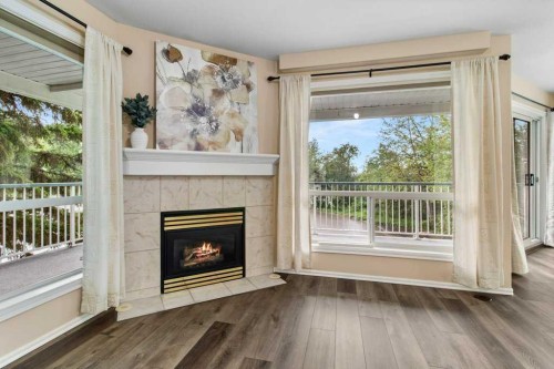 211-6118 53 Avenue, Red Deer, AB - Indoor Photo Showing Living Room With Fireplace