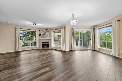 211-6118 53 Avenue, Red Deer, AB - Indoor Photo Showing Living Room With Fireplace