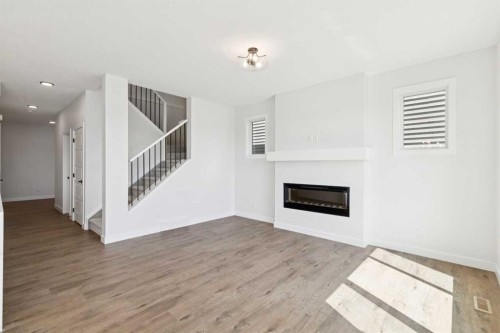 65 Sora Gardens Se, Calgary, AB - Indoor Photo Showing Living Room With Fireplace