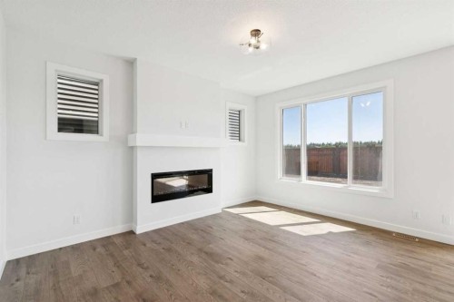 65 Sora Gardens Se, Calgary, AB - Indoor Photo Showing Living Room With Fireplace