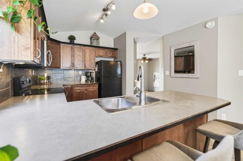 32 Reynolds Road, Sylvan Lake, AB - Indoor Photo Showing Kitchen With Double Sink