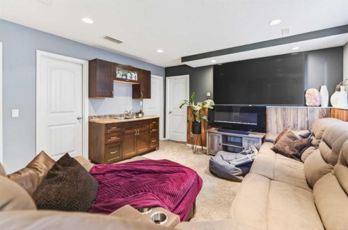 32 Reynolds Road, Sylvan Lake, AB - Indoor Photo Showing Living Room With Fireplace
