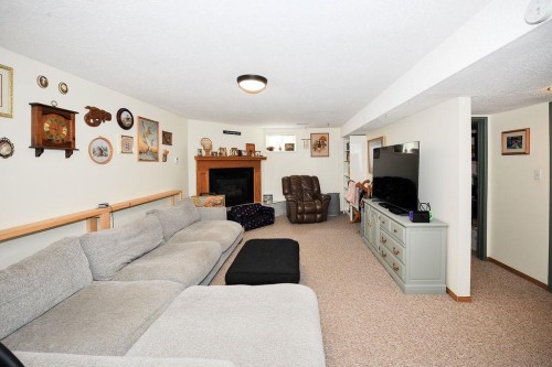4414 67 Street, Camrose, AB - Indoor Photo Showing Living Room With Fireplace