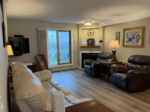 327-4805 45 Street, Red Deer, AB - Indoor Photo Showing Living Room With Fireplace
