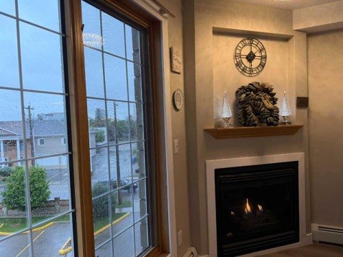 327-4805 45 Street, Red Deer, AB - Indoor With Fireplace