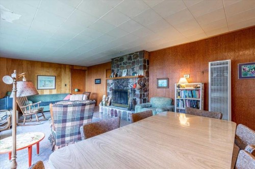 60 Beach Avenue, Itaska Beach, AB - Indoor Photo Showing Dining Room With Fireplace
