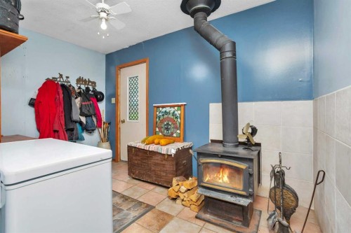 35005 Range Road 15, Rural Red Deer County, AB - Indoor Photo Showing Other Room With Fireplace