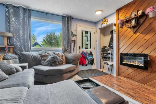 4520 36 Avenue, Ponoka, AB - Indoor Photo Showing Living Room With Fireplace