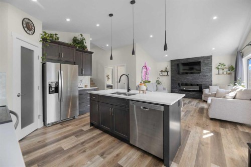 4761 Aspen Lakes Boulevard, Blackfalds, AB - Indoor Photo Showing Kitchen With Fireplace With Double Sink With Upgraded Kitchen