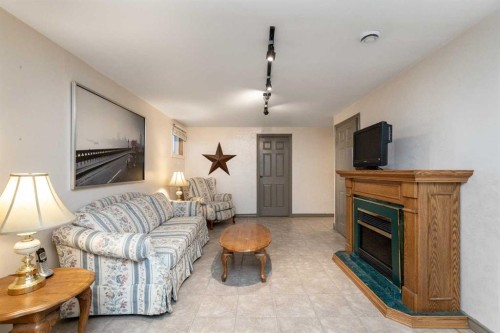 5015 35 Street, Innisfail, AB - Indoor Photo Showing Living Room With Fireplace