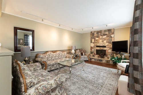 5015 35 Street, Innisfail, AB - Indoor Photo Showing Living Room With Fireplace
